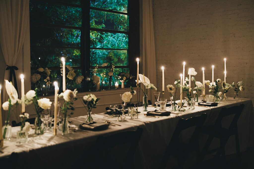 a wedding table at night in chicago with candles and flowers