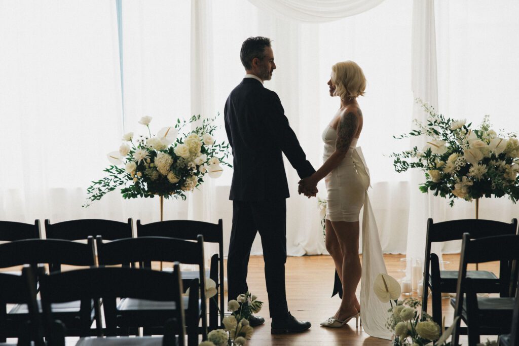 a couple holds hands in a lofted venue in chicago