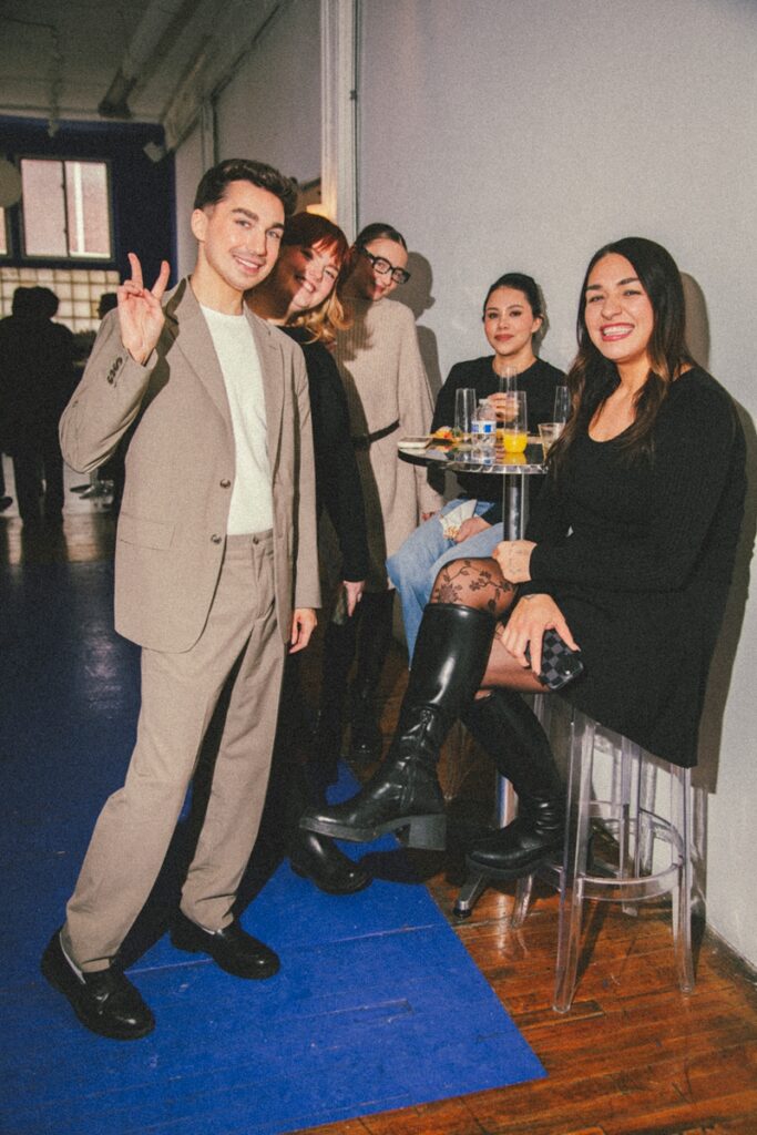 guests hang around a high top table at a event at le loft