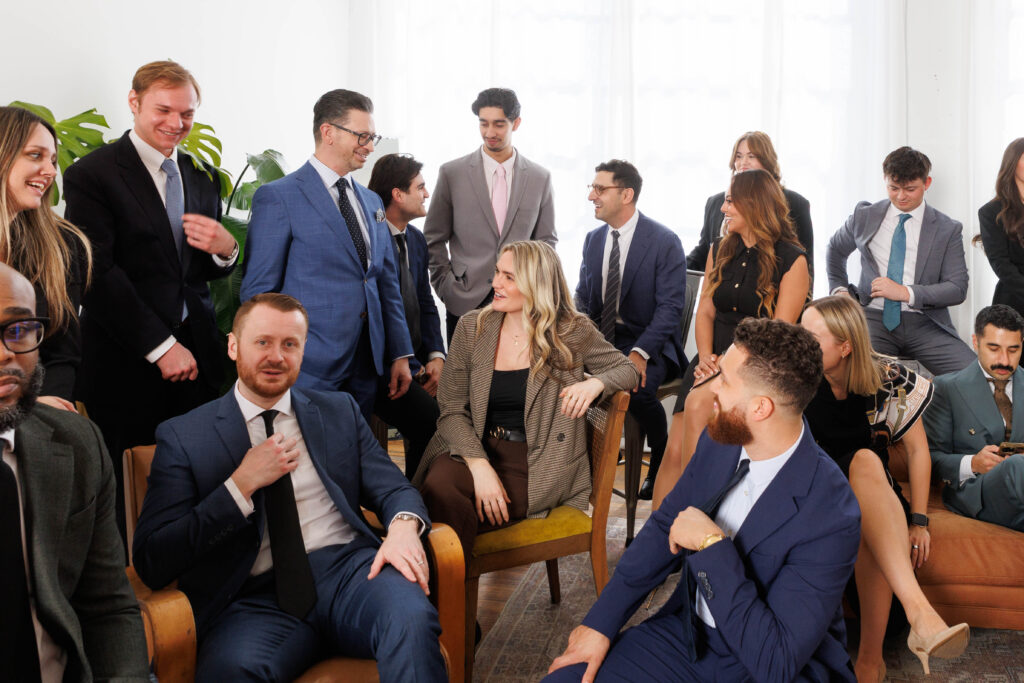 a photo of a group of corporate professionals mingling at le loft