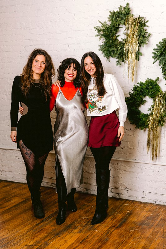 friends pose at a holiday party together at le loft a chicago venue